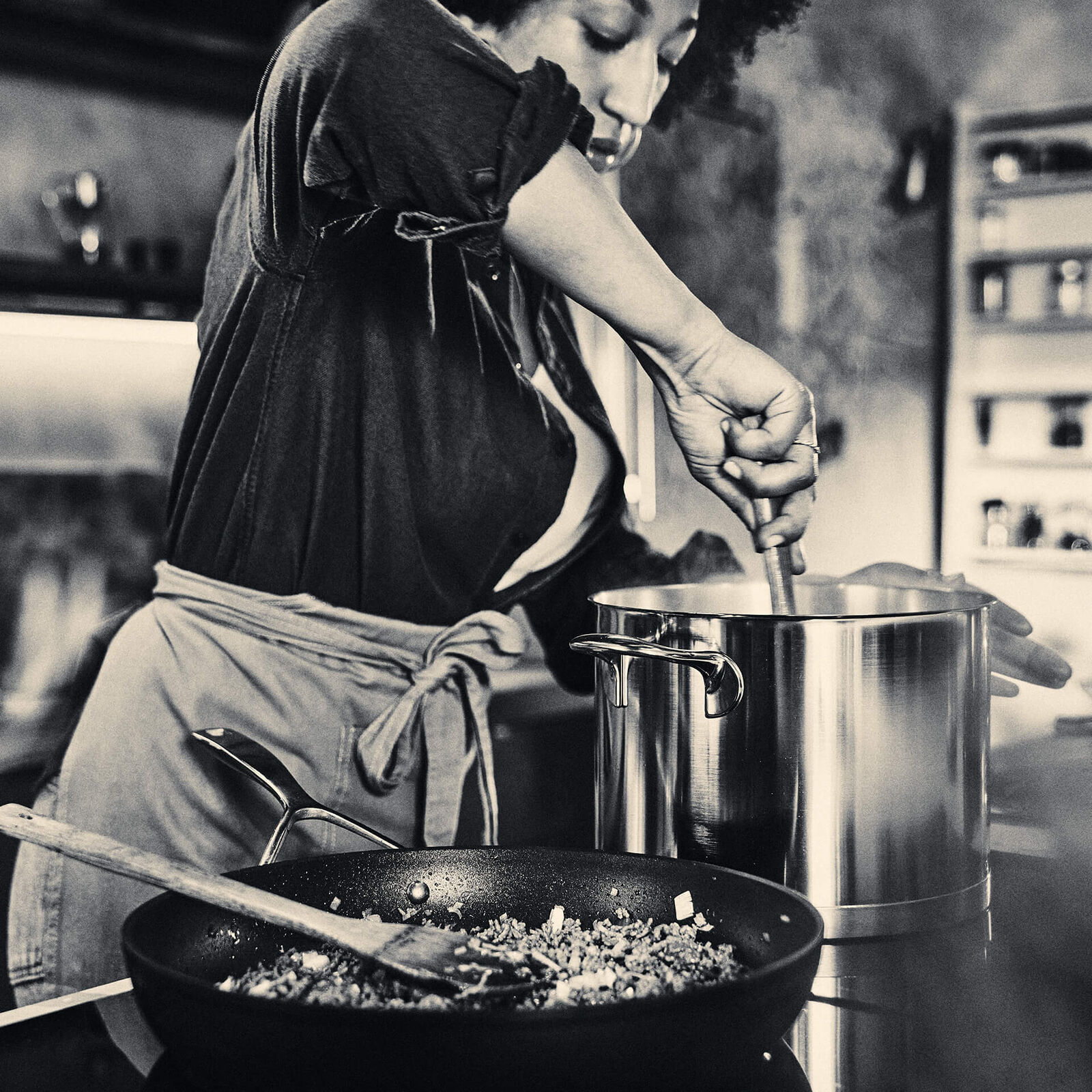 Demeyere stainless steel cookware in a dark professional kitchen setting