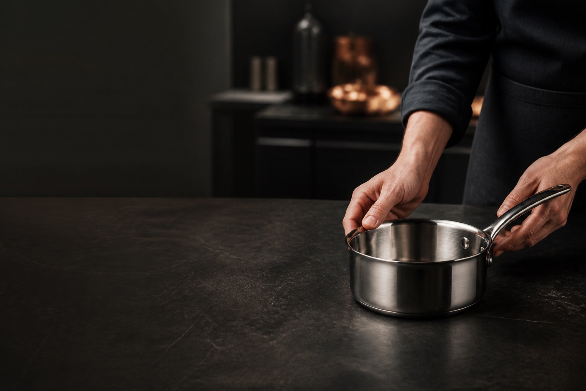 Demeyere stainless steel cookware arranged in a warm, modern kitchen